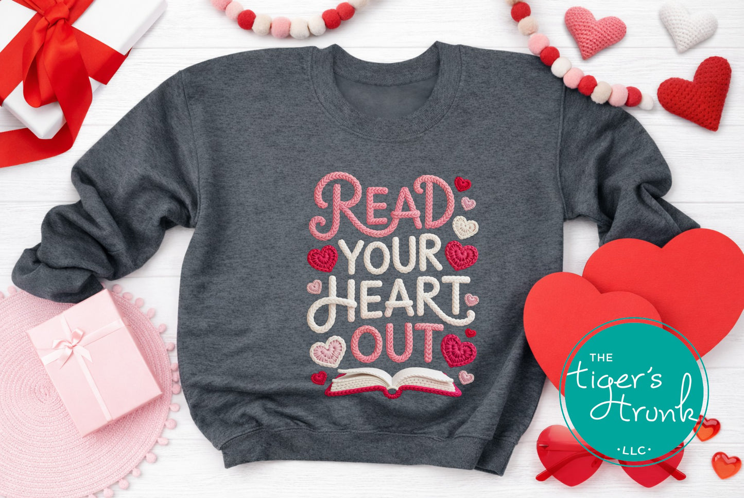 Gray sweatshirt with 'Read Your Heart Out' text surrounded by heart-shaped decorations and a gift box.