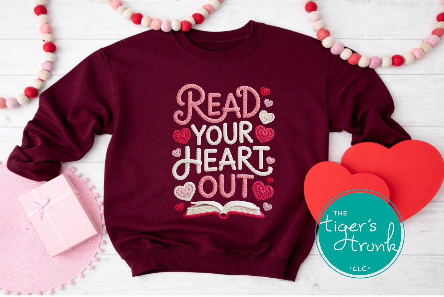 Maroon sweatshirt with 'Read Your Heart Out' text on a white background with heart decorations.
