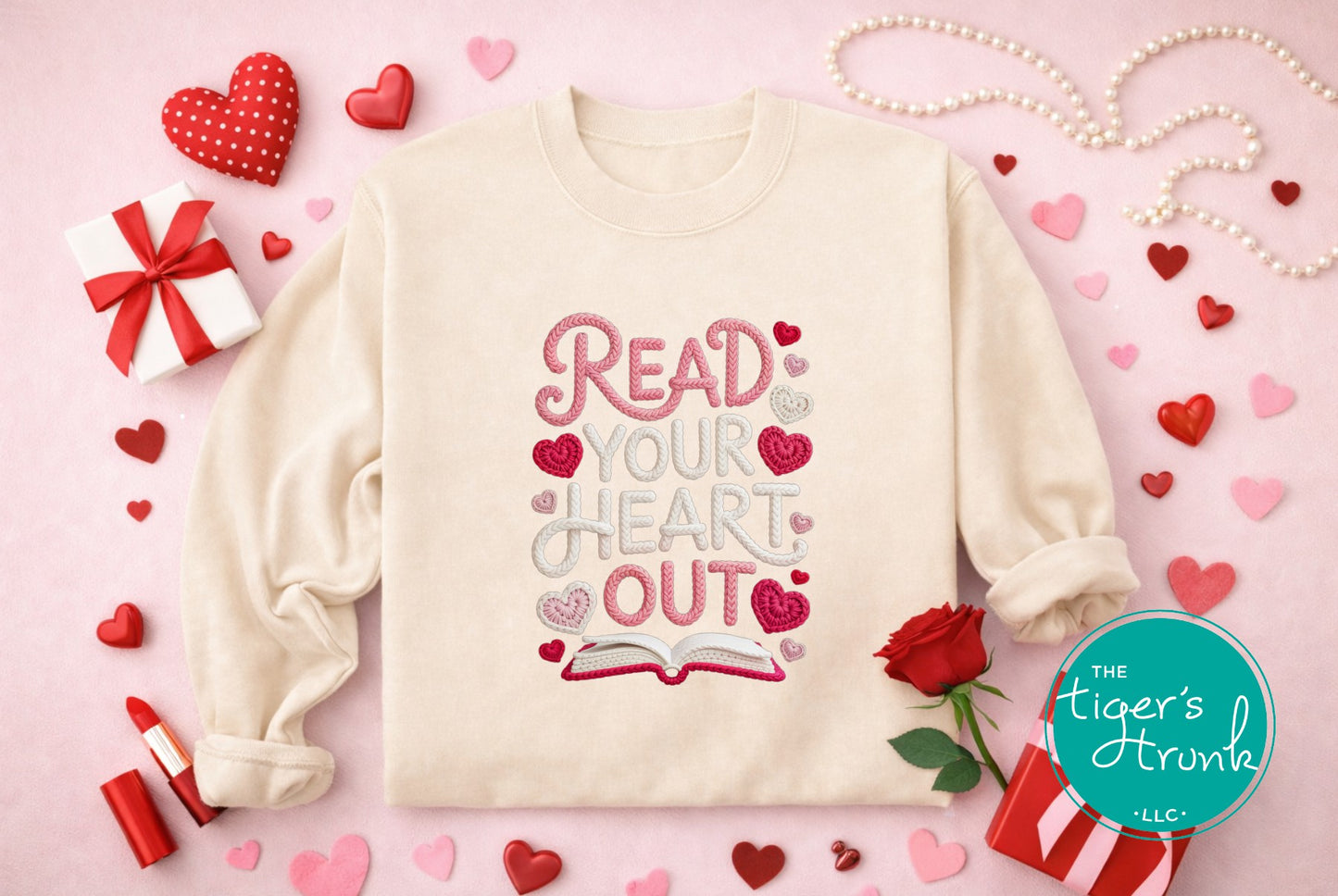 Beige sweatshirt with 'Read Your Heart Out' text on a pink background with hearts, roses, and gift boxes.
