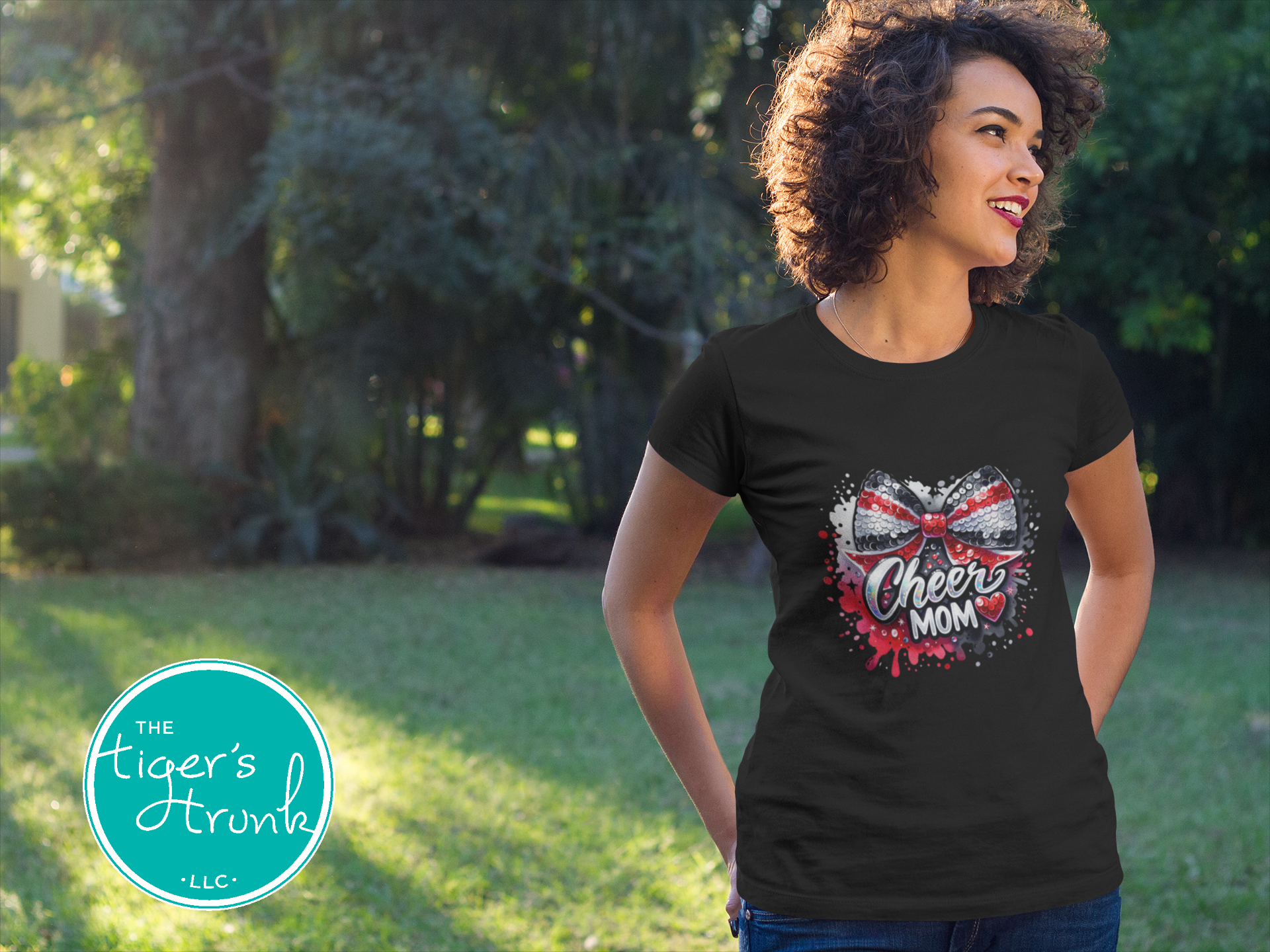 Woman wearing a black t-shirt with 'Cheer Mom' design outdoors