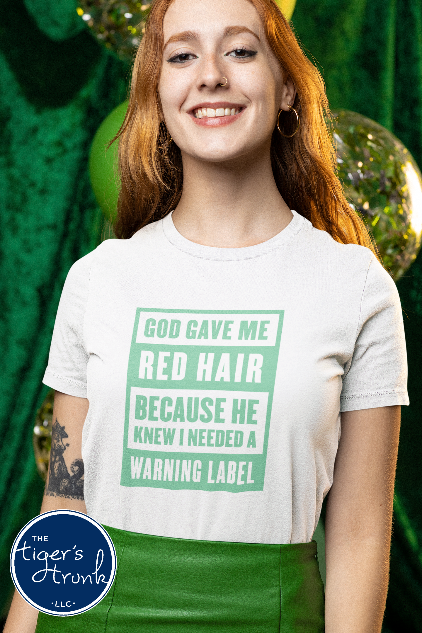 Woman with red hair wearing white St. Patrick’s Day red hair warning label shirt with green lettering.
