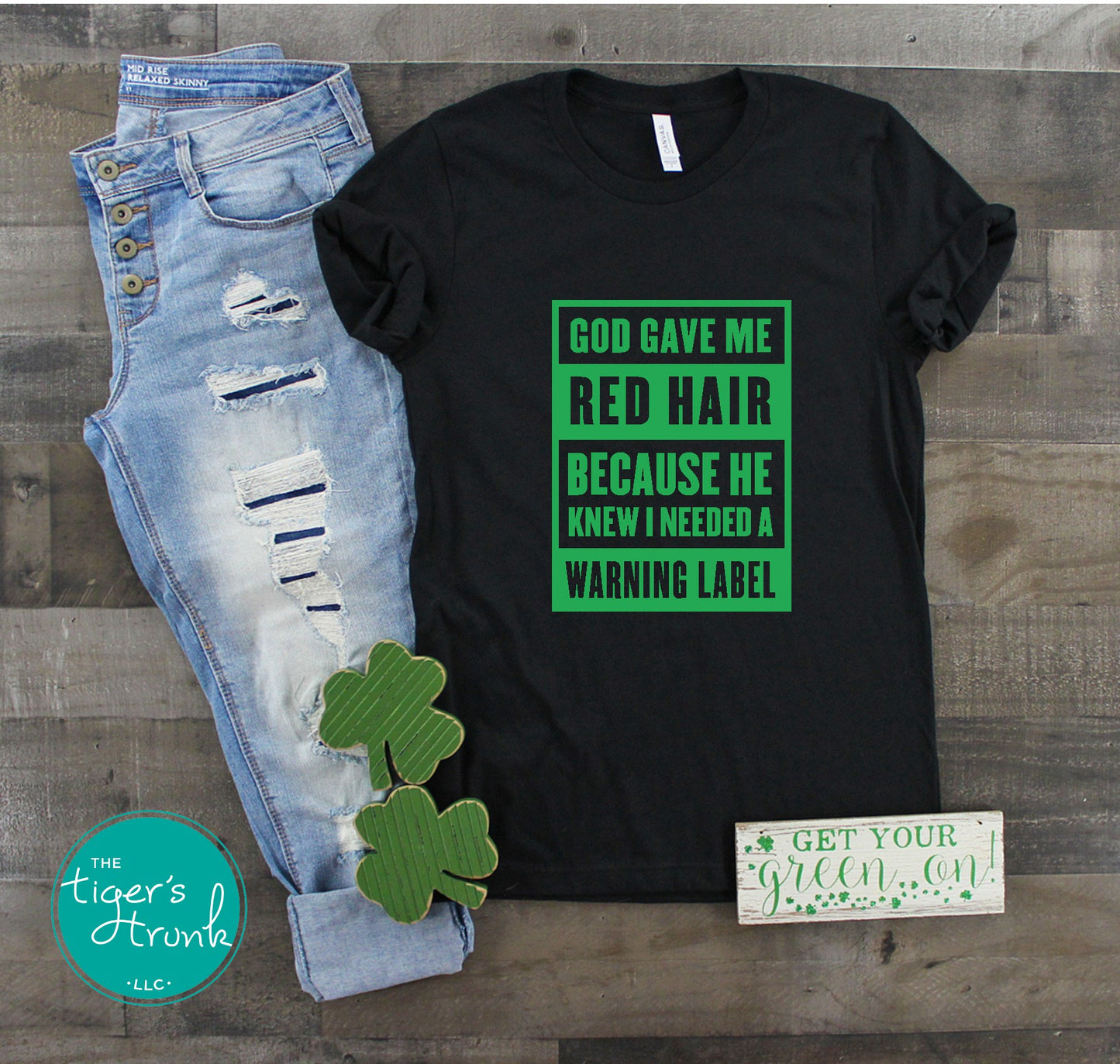 Black St. Patrick’s Day red hair warning label shirt with shamrock accents.