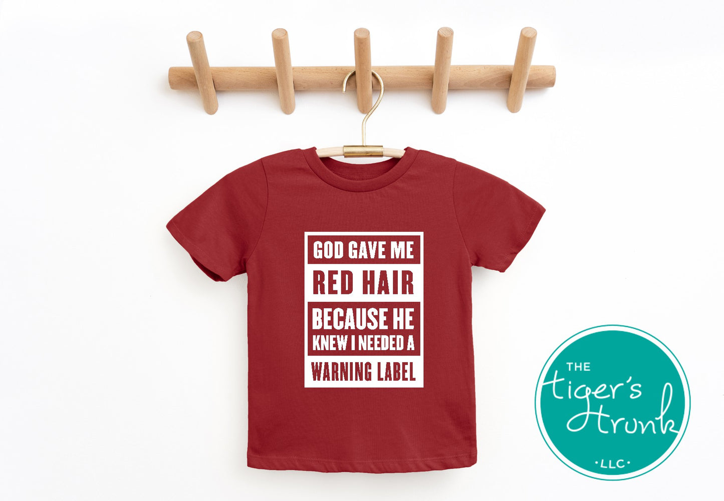 youth red shirt with white text saying god gave me red hair because he knew I needed a warning label