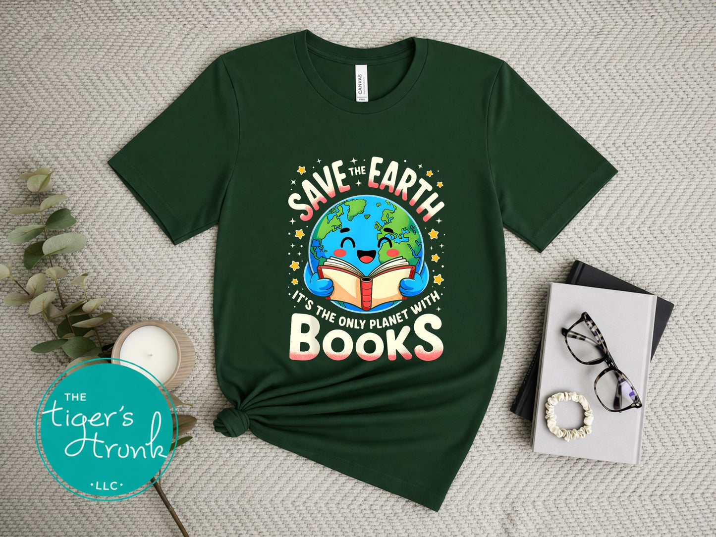 Green t-shirt with 'Save the Earth, It's the Only Planet with Books' design on a textured surface.