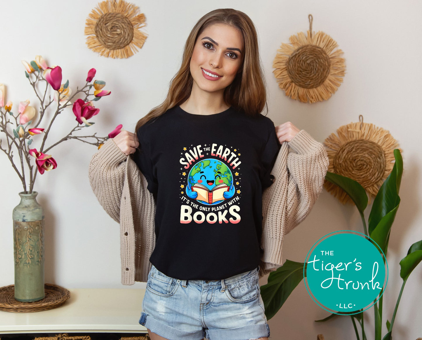 Woman wearing a black t-shirt with an environmental message, standing in a room with decorative elements.