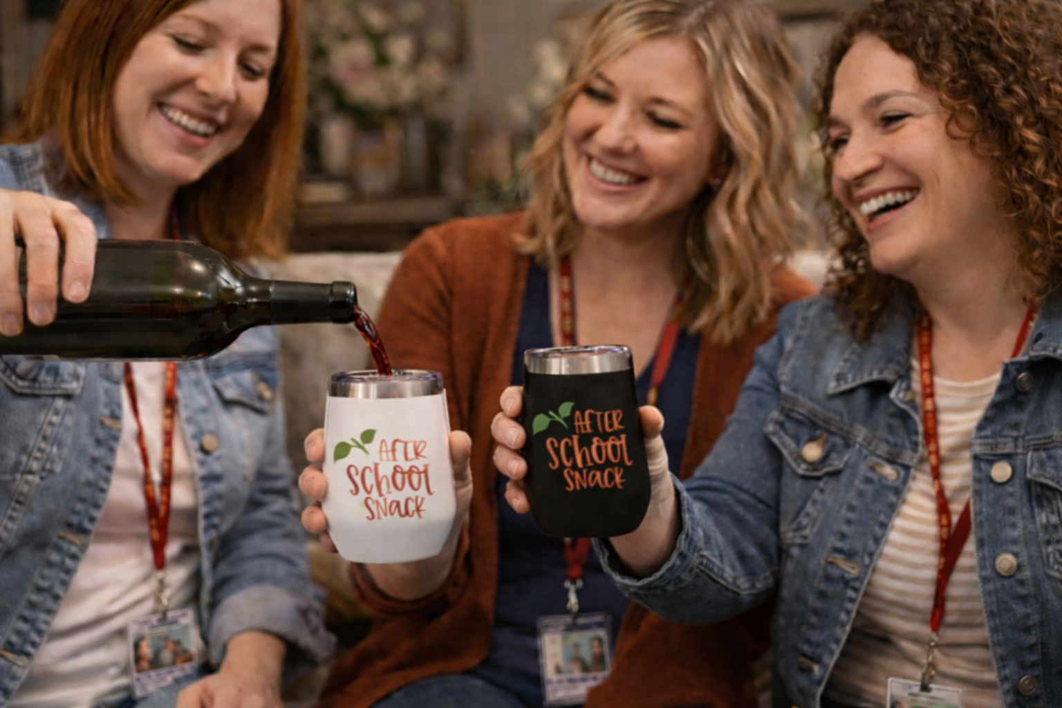 Three women sitting together, one pouring a drink into a 'After School Snack' cup.