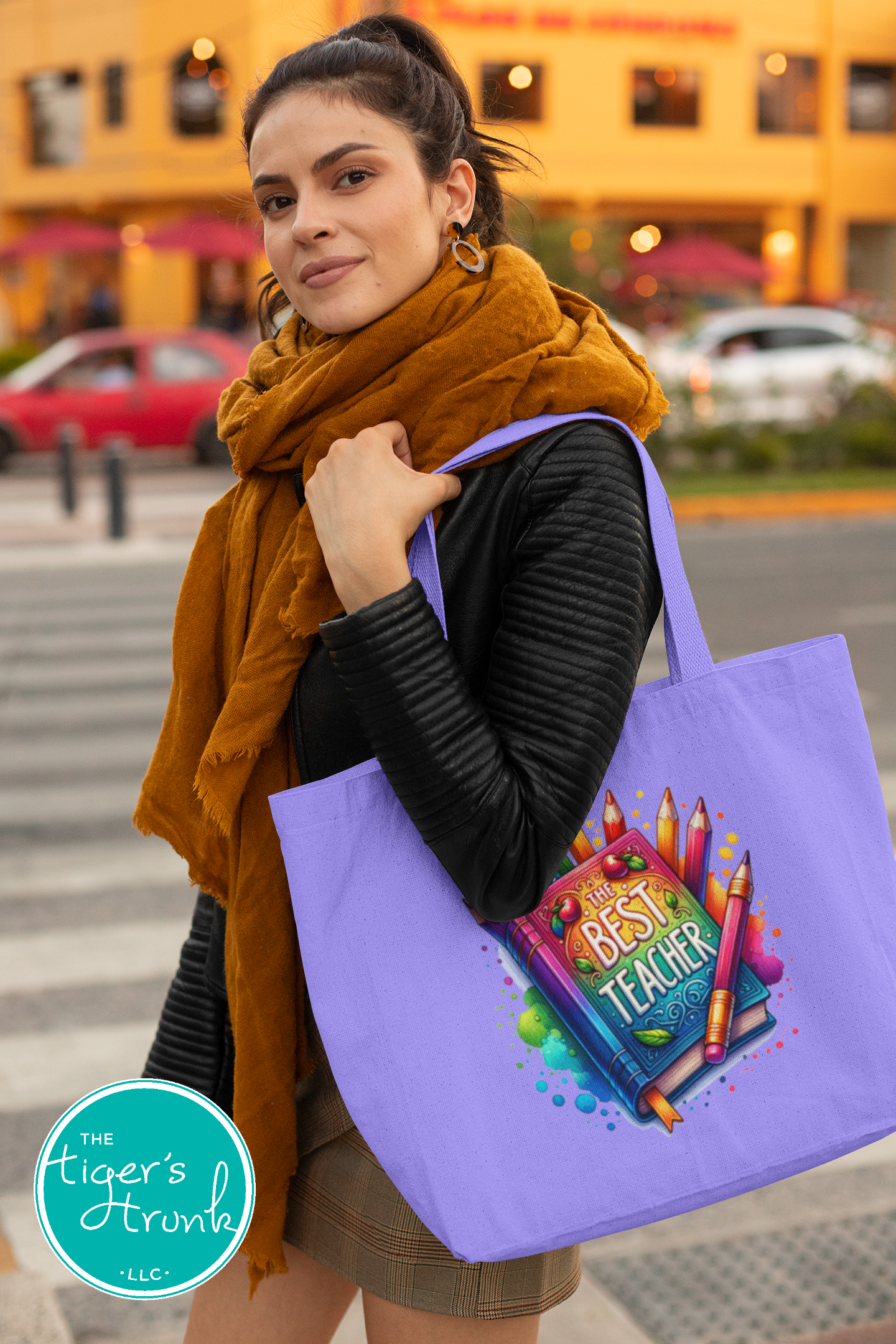 Heavy-duty cotton canvas tote bag with colorful "The Best Teacher" graphic, features gusset and long handles for classroom or everyday use