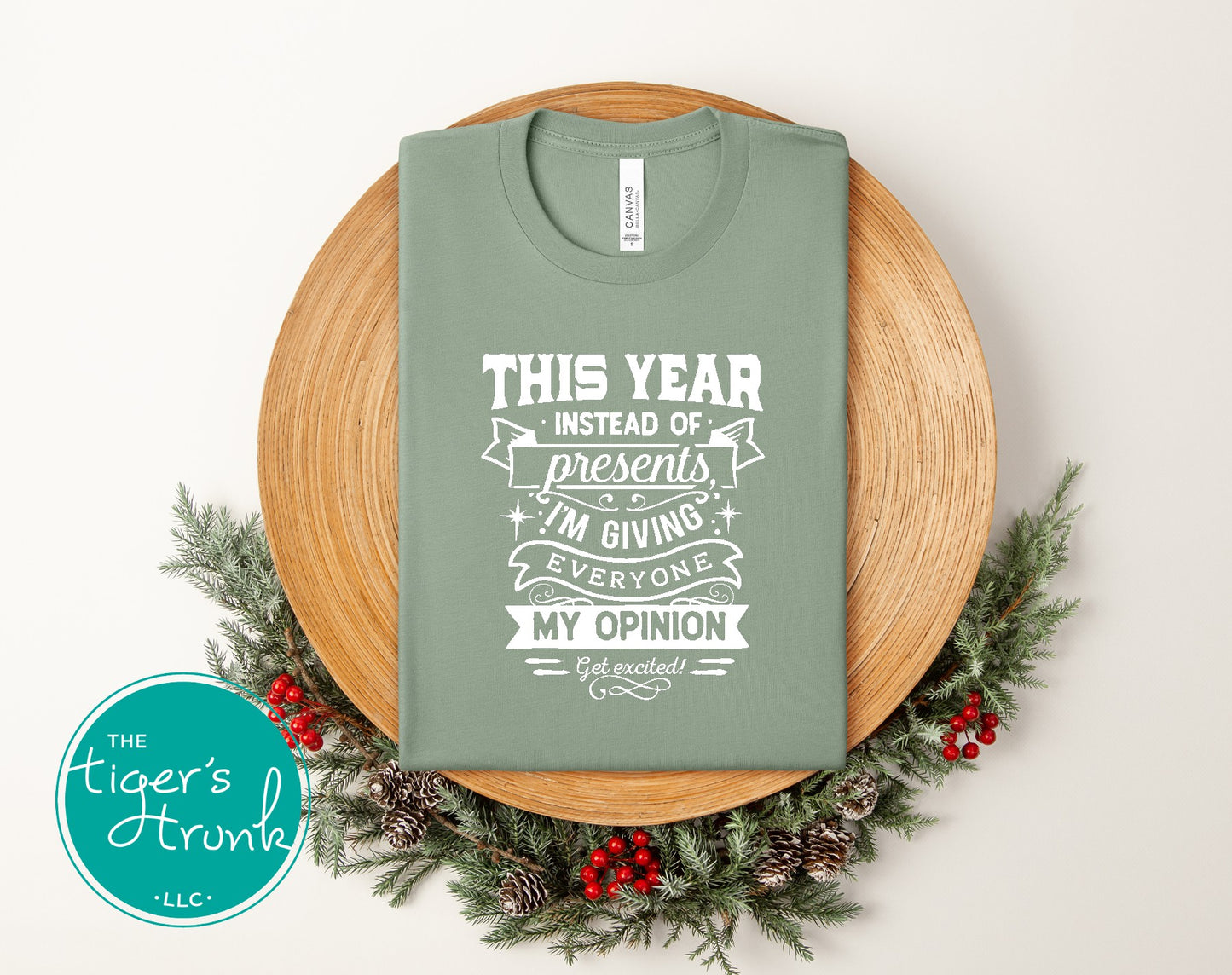 Green t-shirt with humorous text design on a wooden board with decorative elements, featuring 'The Tiger's Trunk' logo.