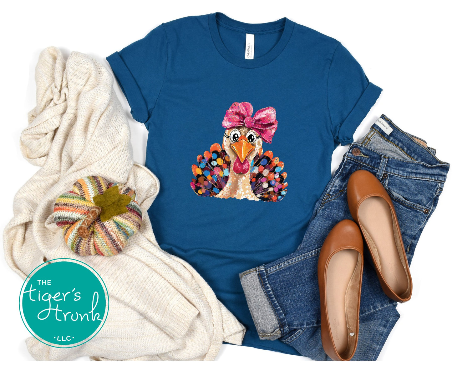 Blue t-shirt with a turkey graphic and accessories on a white background