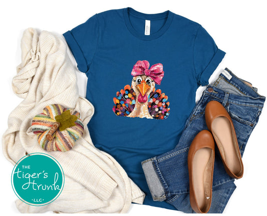 Blue t-shirt with a turkey graphic and accessories on a white background