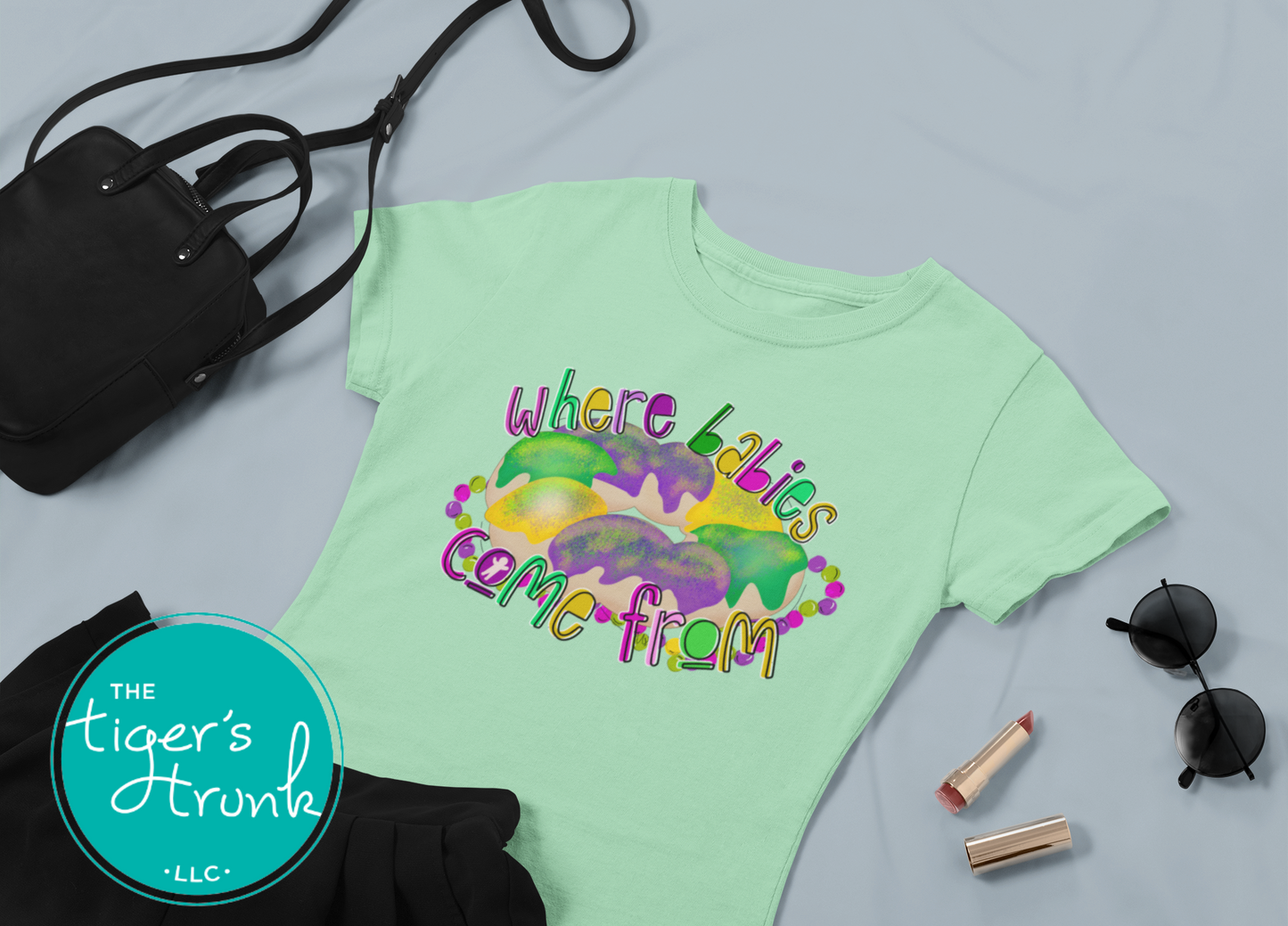 Mardi Gras t-shirt with a watercolor king cake graphic and the phrase Where Babies Come From, perfect for parades and parties.