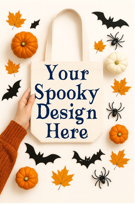 Tote bag with 'Your Spooky Design Here' text, surrounded by Halloween decorations like pumpkins, leaves, and bats.