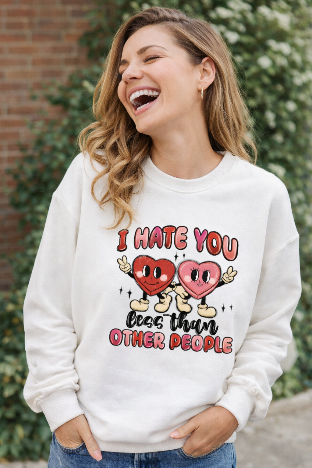 Woman wearing a white sweatshirt with a humorous graphic and text.