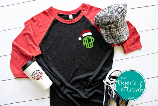 Black and red raglan holiday shirt with round green monogram and Santa hat