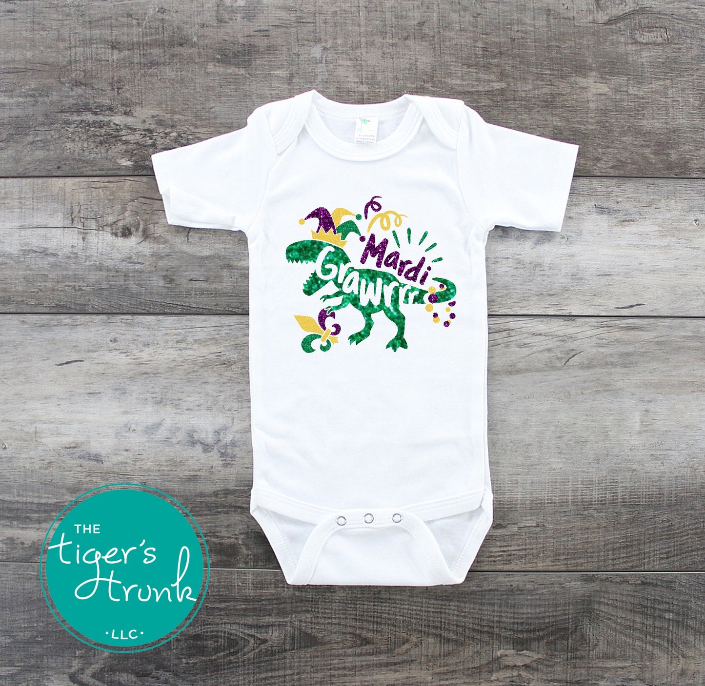 Kids Mardi Gras t-shirt featuring a playful dinosaur design with the phrase Mardi Grawrr, perfect for parades and celebrations.