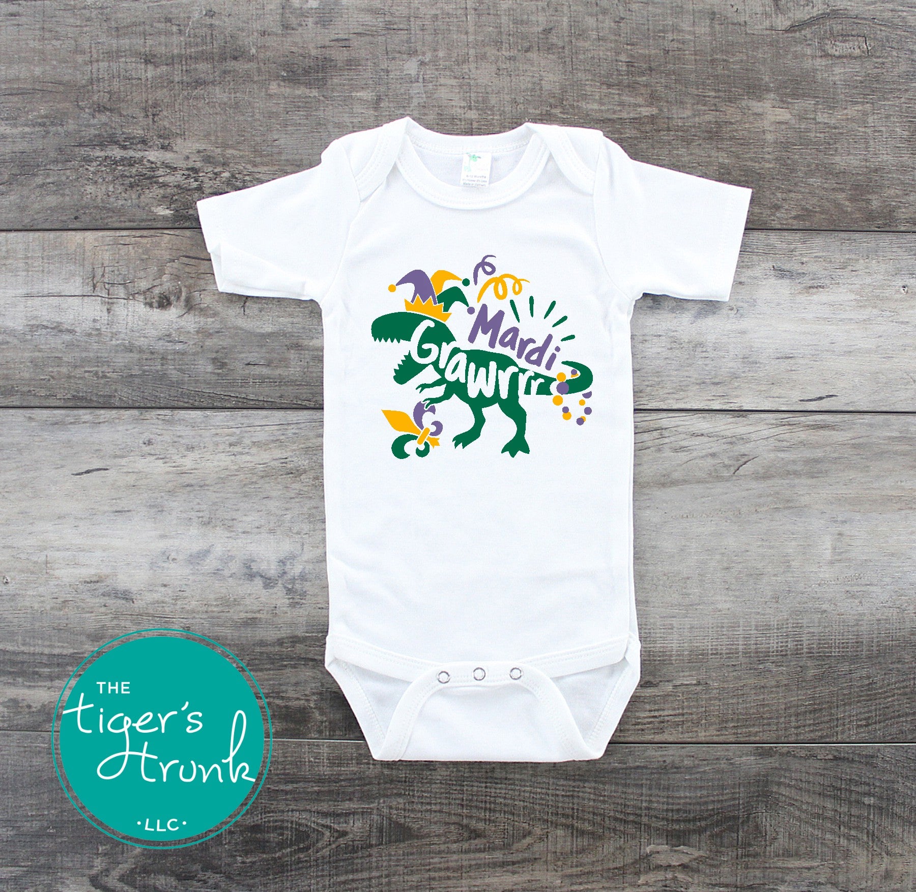 Kids Mardi Gras t-shirt featuring a playful dinosaur design with the phrase Mardi Grawrr, perfect for parades and celebrations.