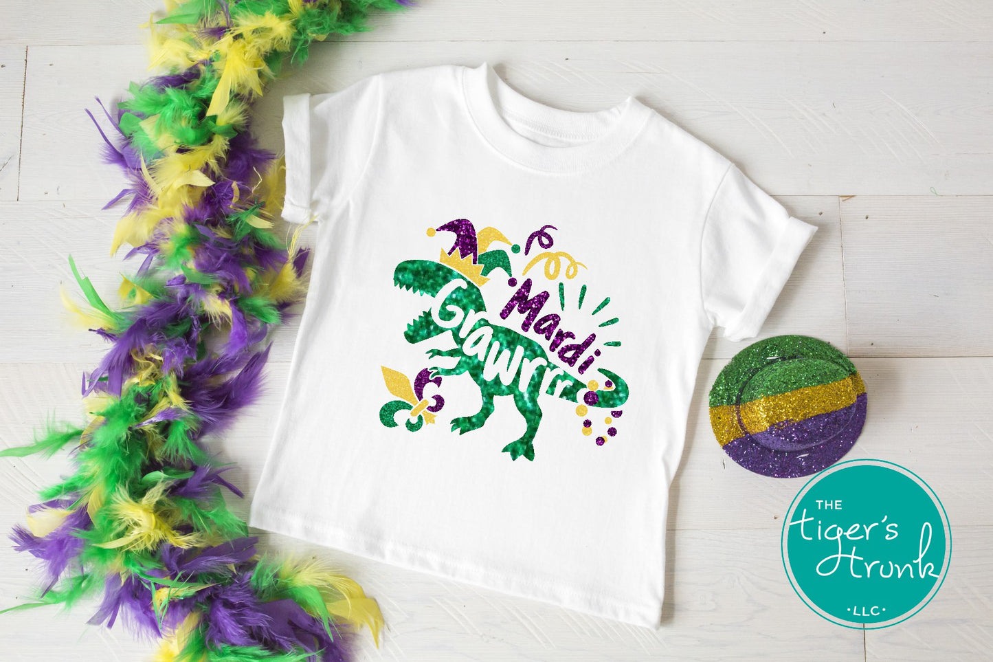 Kids Mardi Gras t-shirt featuring a playful dinosaur design with the phrase Mardi Grawrr, perfect for parades and celebrations.