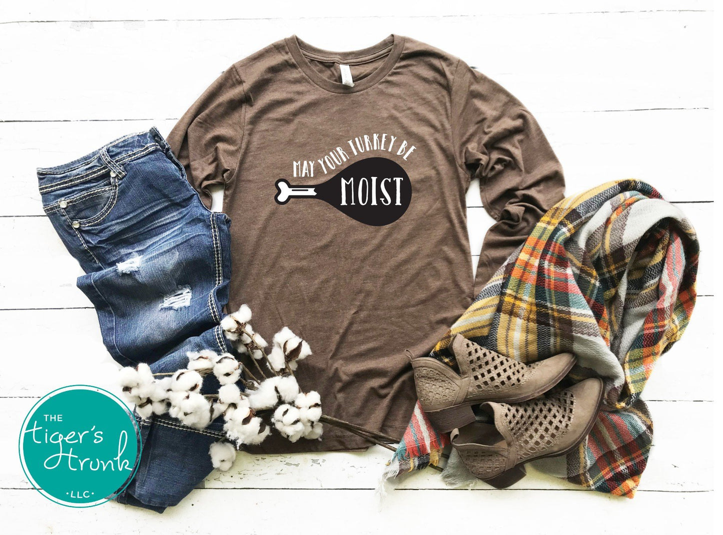 Funny brown Thanksgiving shirt with text “May Your Turkey Be Moist,” styled with jeans and fall accessories