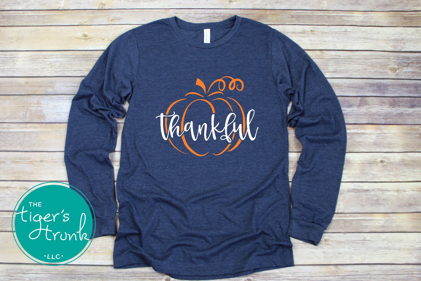 Heather navy long sleeve thanksgiving shirt with orange pumpkin and white thankful text