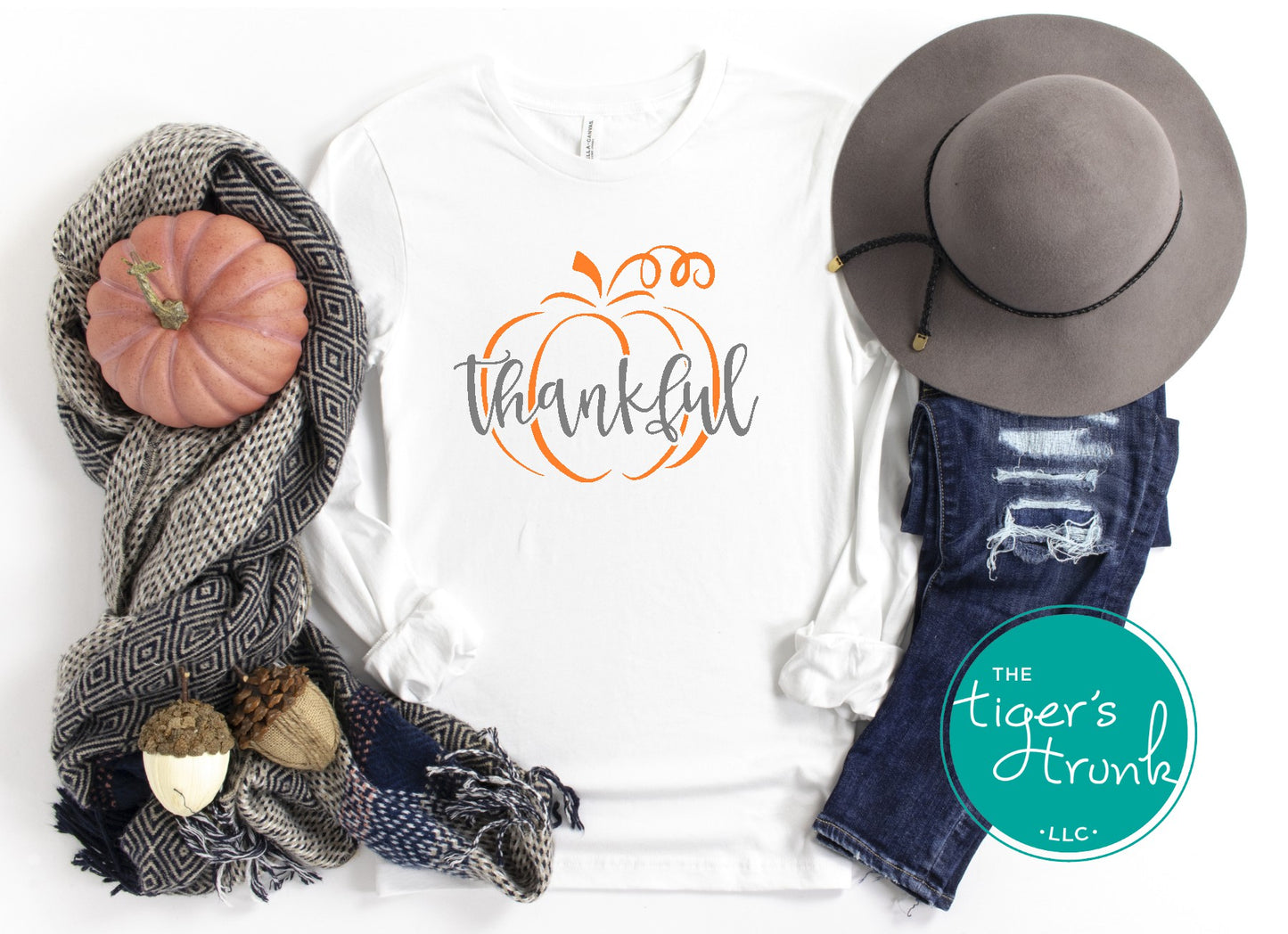 White long sleeve thanksgiving shirt with gray thankful text and orange pumpkin