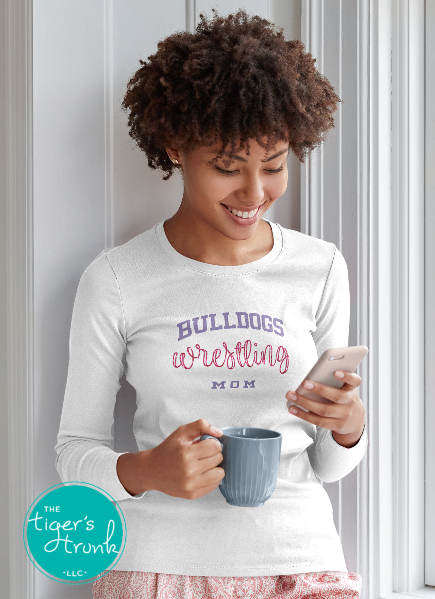 woman wearing white wrestling mom shirt customized with team mascot and school colors