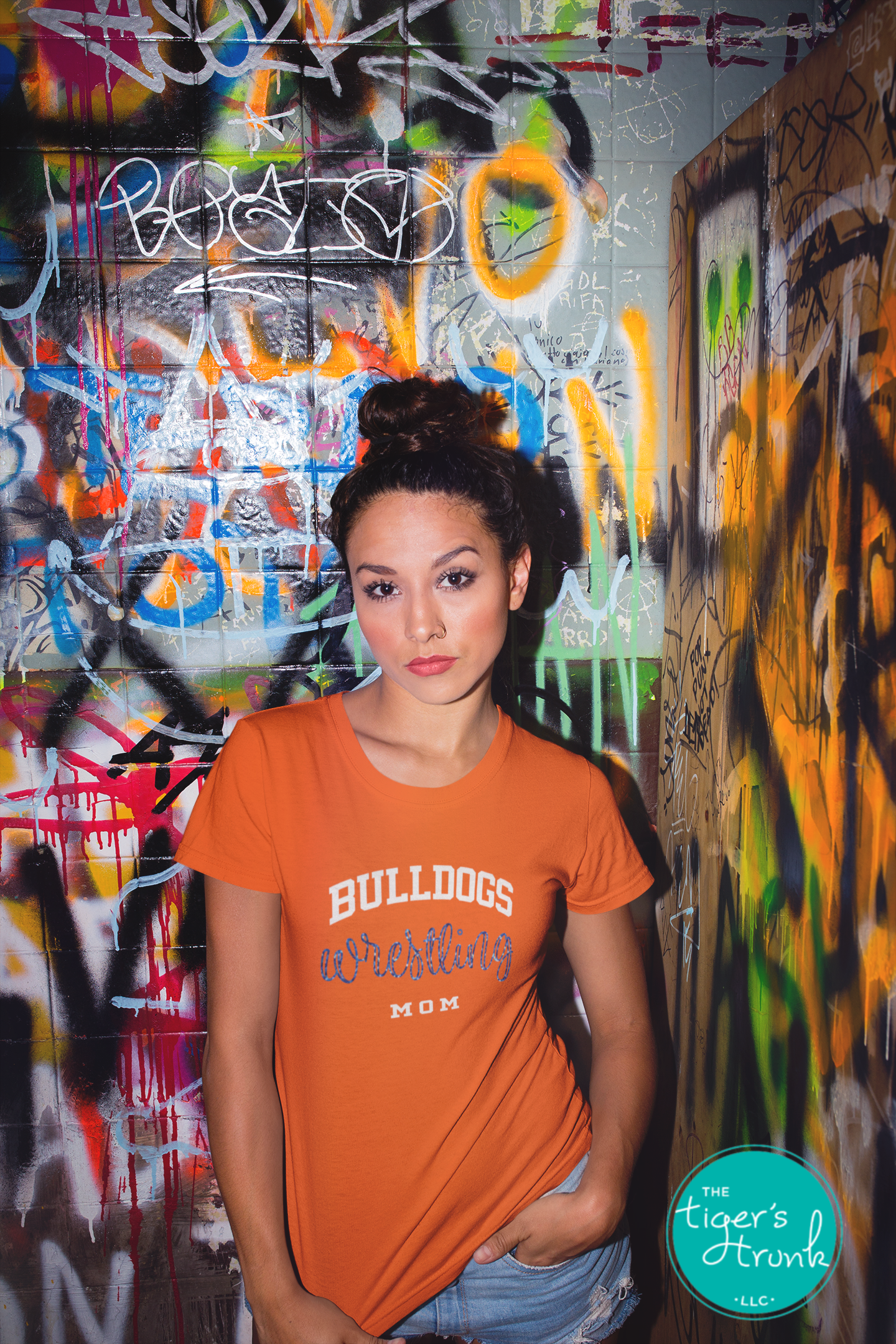 woman wearing orange wrestling mom shirt customized with team mascot name and school colors